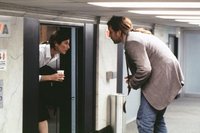Maxine (Keener) and Craig (Cusack) meet on the 7 1/2 floor
